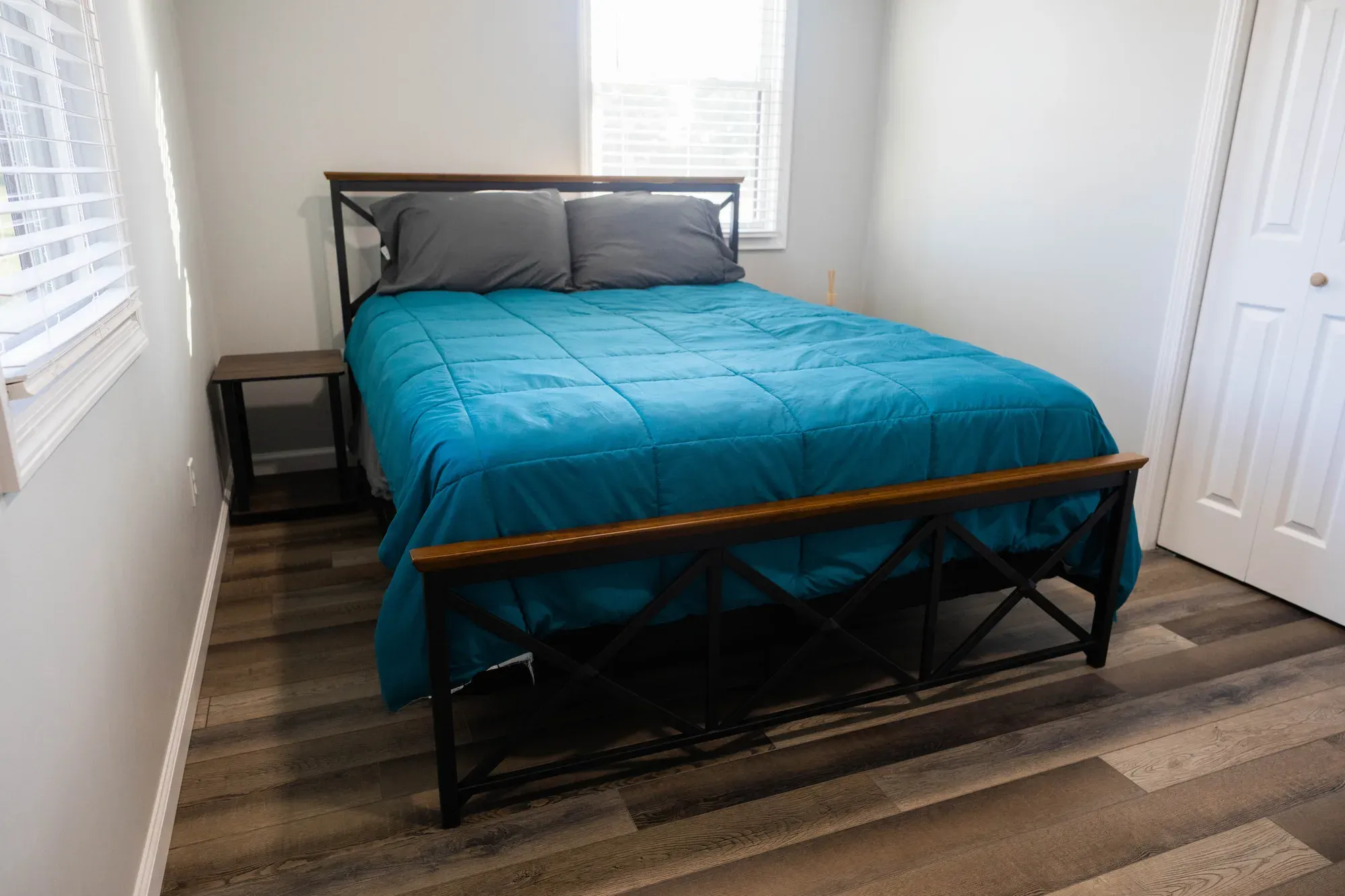 Bedroom with a queen bed and a teal comforter