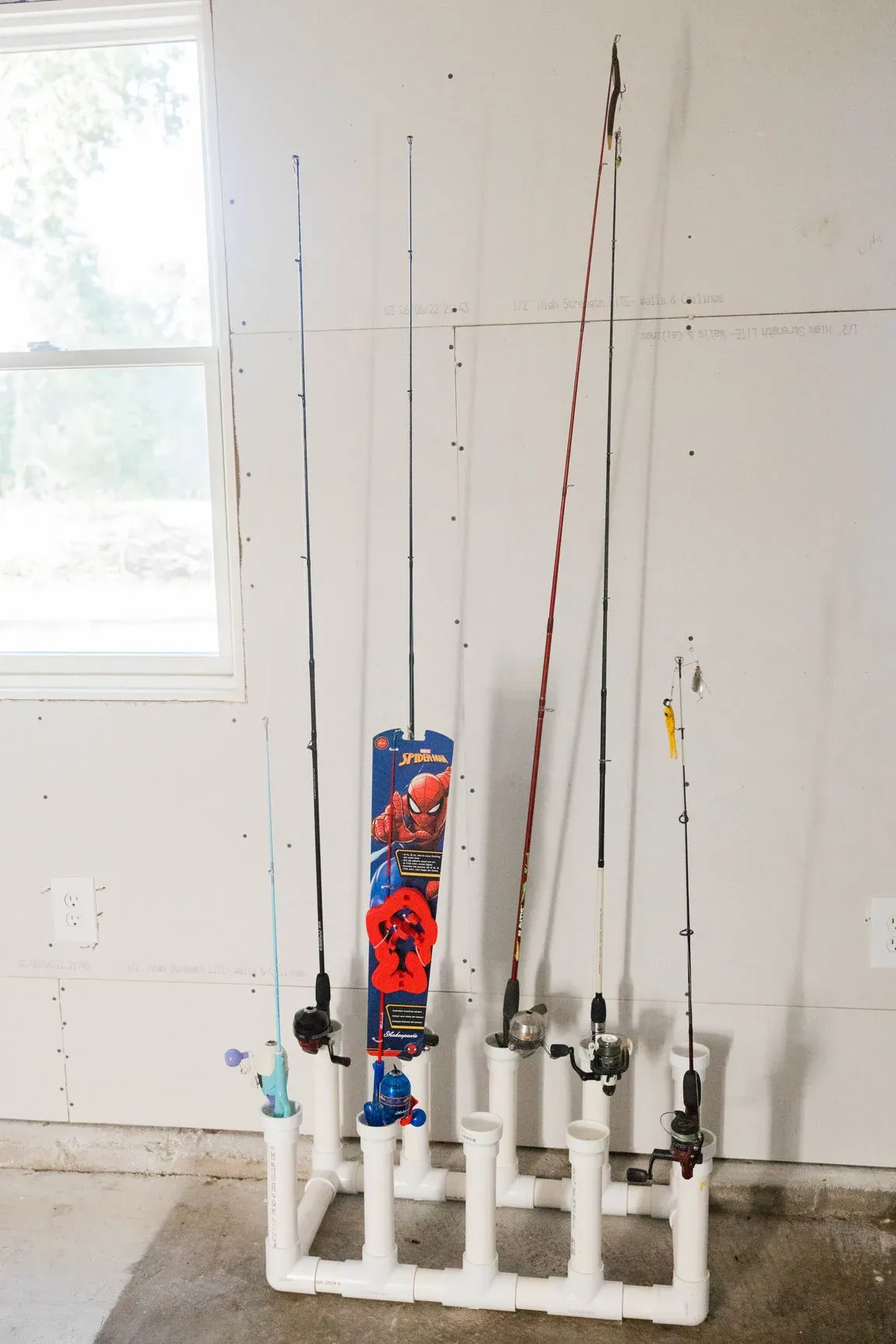 Rack of fishing poles at the farmhouse, including a kid-size pole