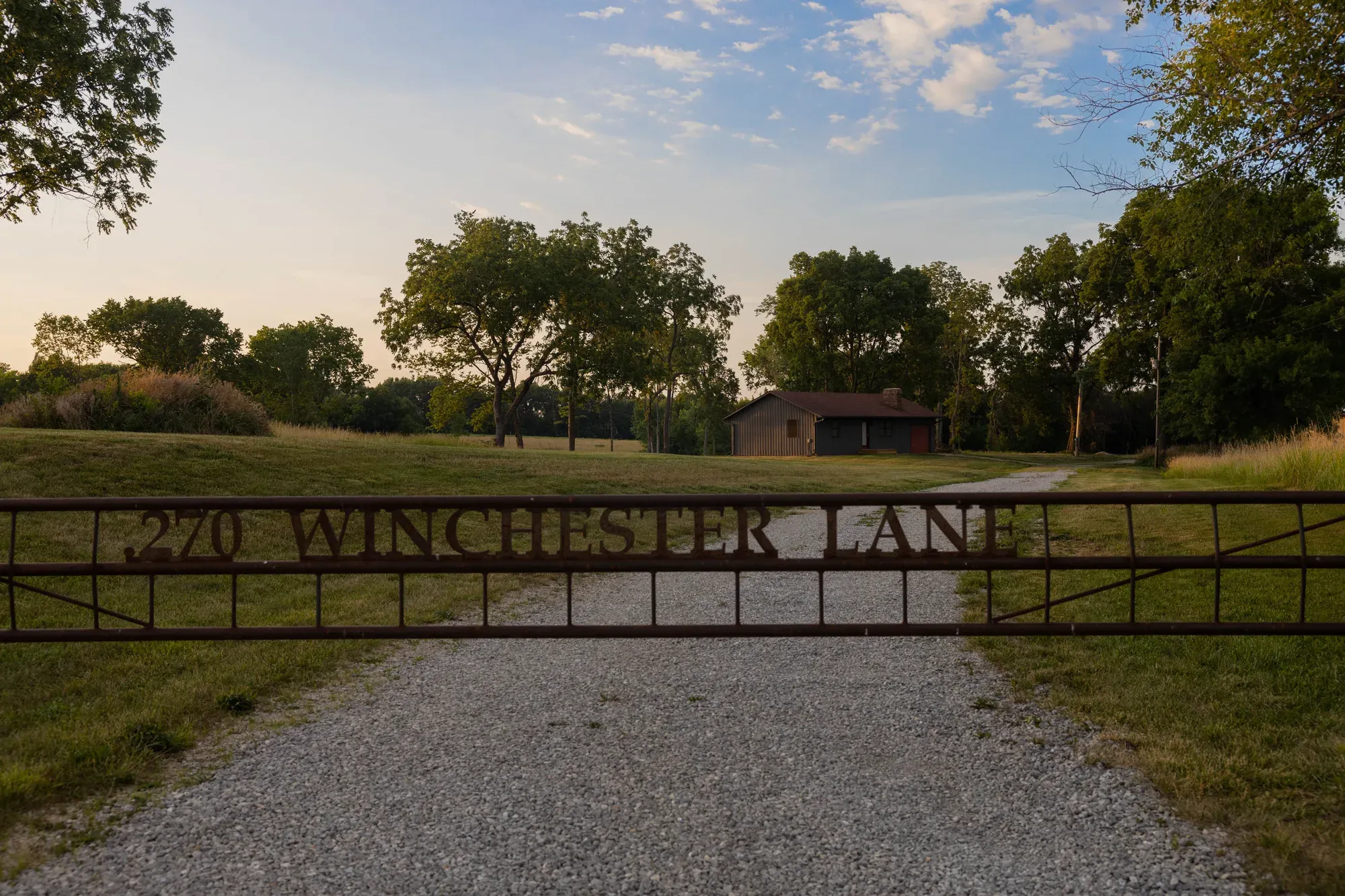 Gravel drive and gate with the 270 Winchester Lane sign near Bogard, Missouri